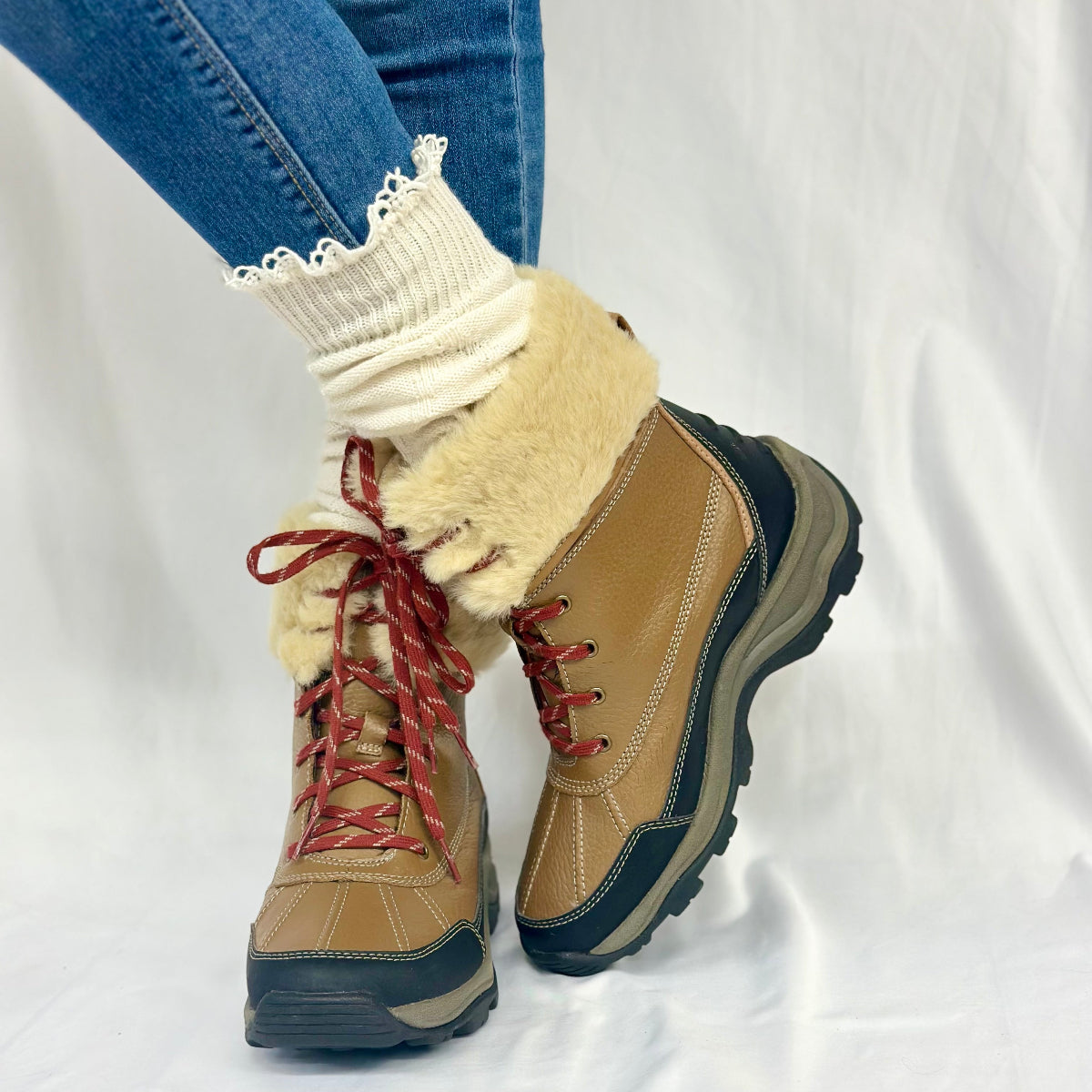 Tan winter boots with fur lining worn with white socks and blue jeans on a white background, MOUNTAIN lace knee boot socks - natural