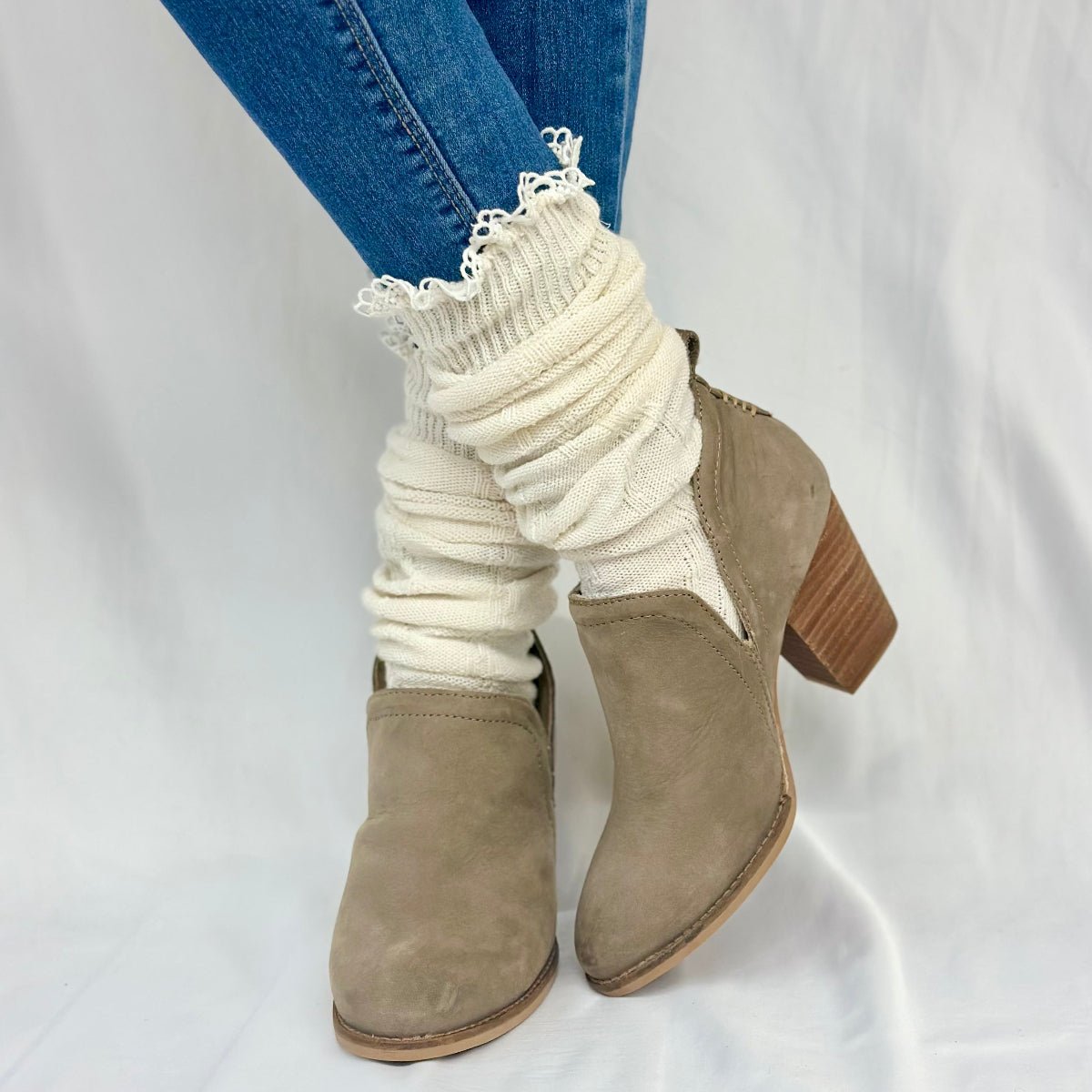 White ribbed socks with lace trim worn with brown ankle boots on a white background, MOUNTAIN lace knee boot socks - natural