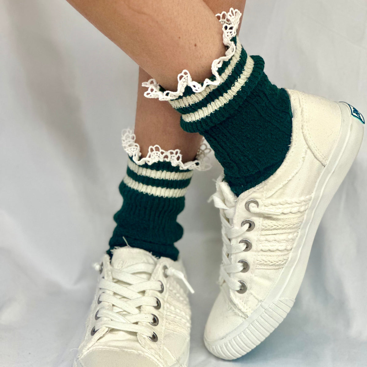 White sneakers with green and white striped socks on a plain background, VARSITY striped crew socks - hunter green