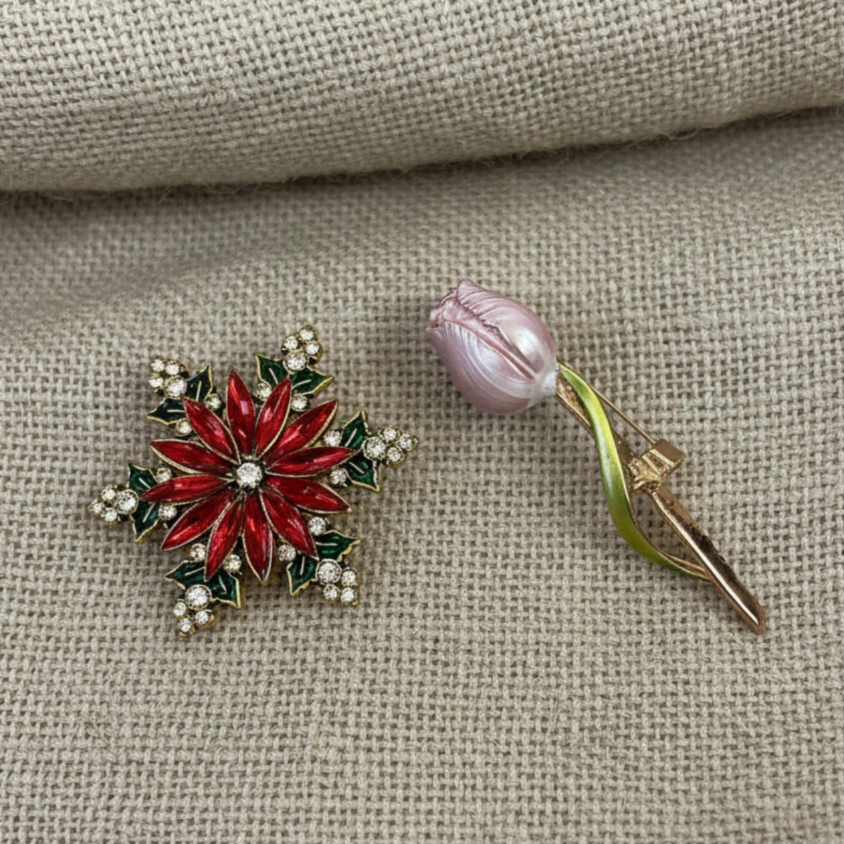 Red snowflake-shaped brooch with gold accents on a light gray , Black Brocade Evening Bag with Interchangeable Brooches – Set of 2 Pins background
