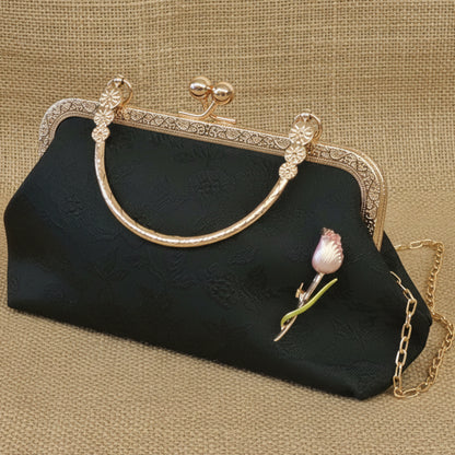 Black handbag with gold frame and pink flower detail on a marble surface, Black Brocade Evening Bag with Interchangeable Brooches – Set of 2 Pins