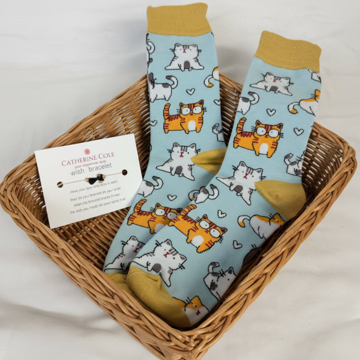 Pair of socks with cartoon cat and tiger design on a white background