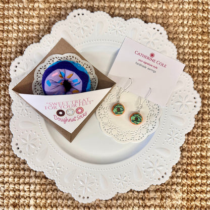 Colorful doughnut sock gift set on white lace plate with earrings – sweet treat for your feet
