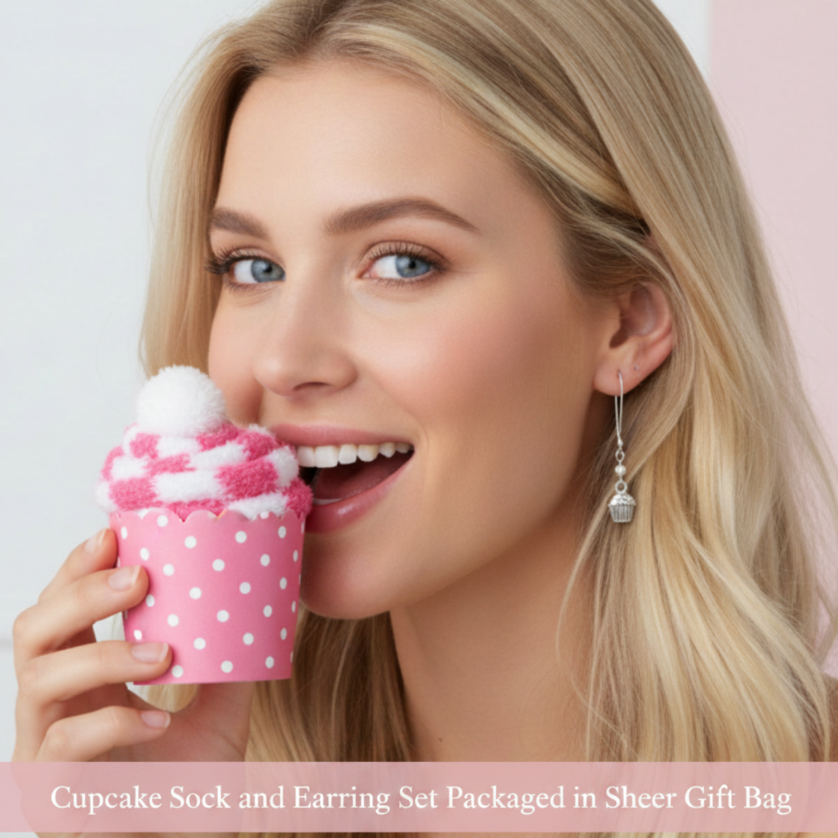 A smiling blonde woman holds a pink cupcake-shaped sock near her face, wearing a dangling silver earring. Text at the bottom reads 'Cupcake Sock and Earring Set Packaged in Sheer Gift Bag'.