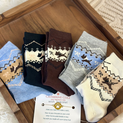 Set of patterned socks with a Catherine Cole card on a wooden surface, Dog Lover Crew Socks 5-Pack Bundle with Paw Wish Bracelet - Women's 6-9  Catherine Cole signature socks