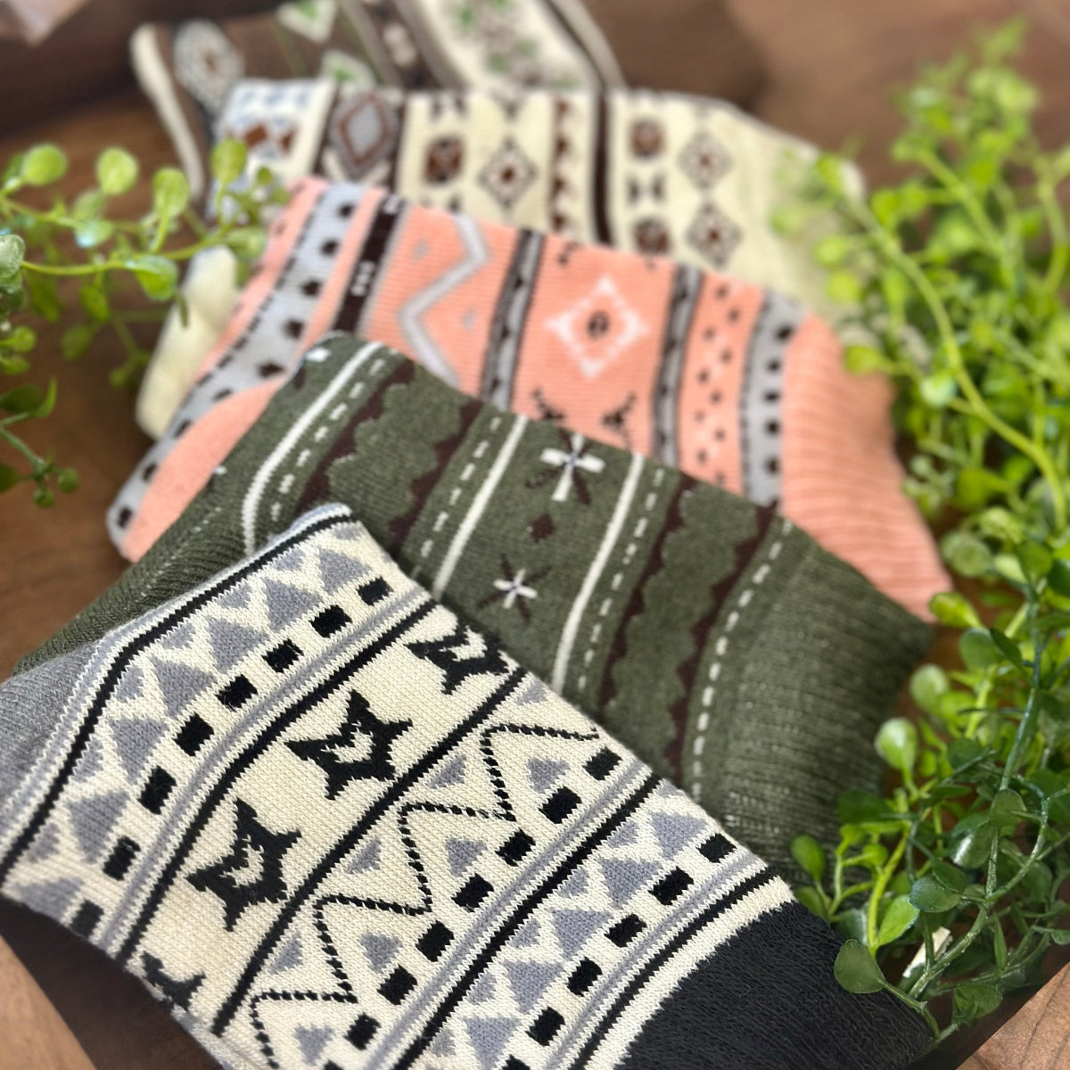 Three pairs of patterned socks on a wooden surface with plants in the background, Geometric Patterned Ankle Socks 5-Pack Bundle with Wish Bracelet - Women's 6-9