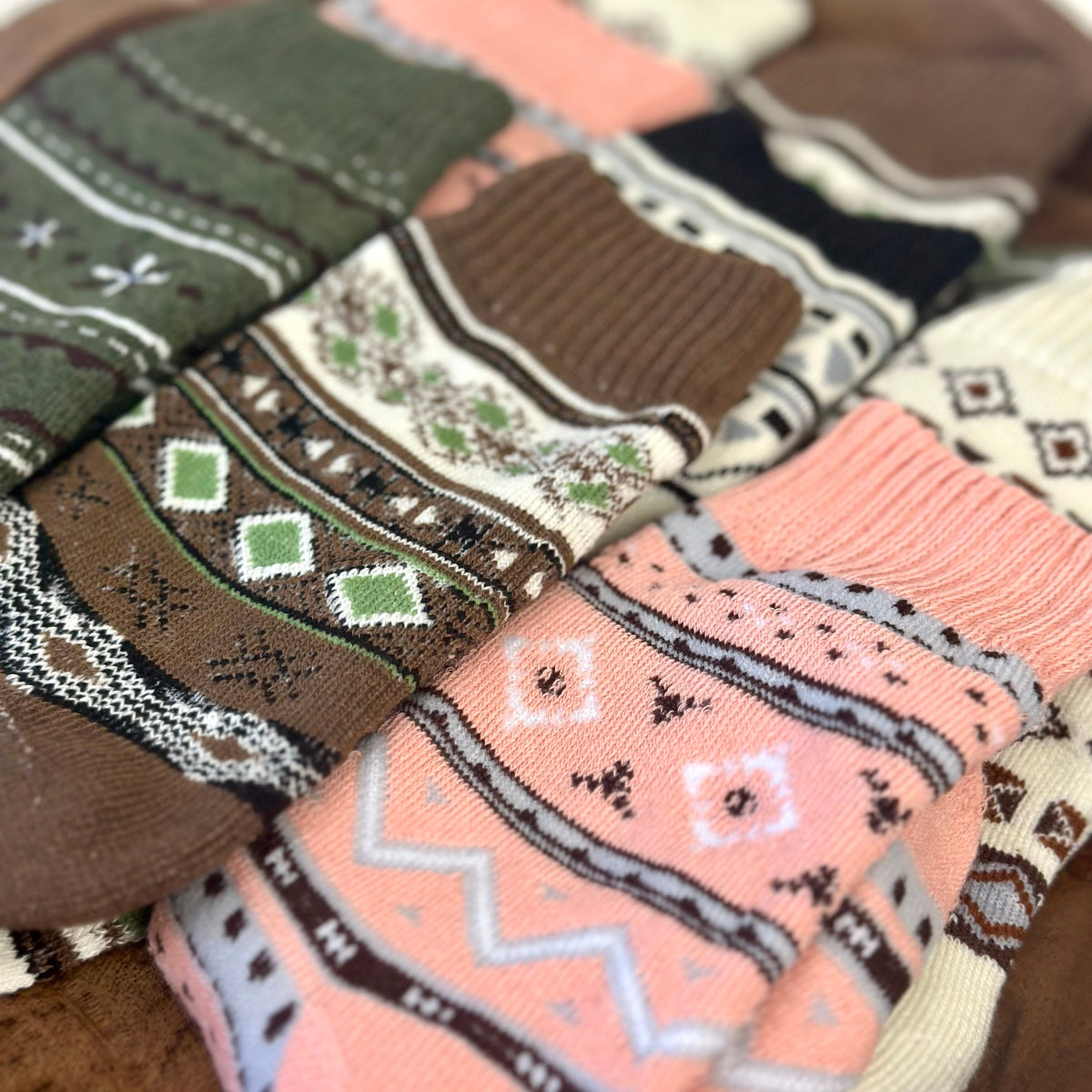 Close-up of patterned socks in various colors and designs. Geometric Patterned Ankle Socks 5-Pack Bundle with Wish Bracelet - Women's 6-9