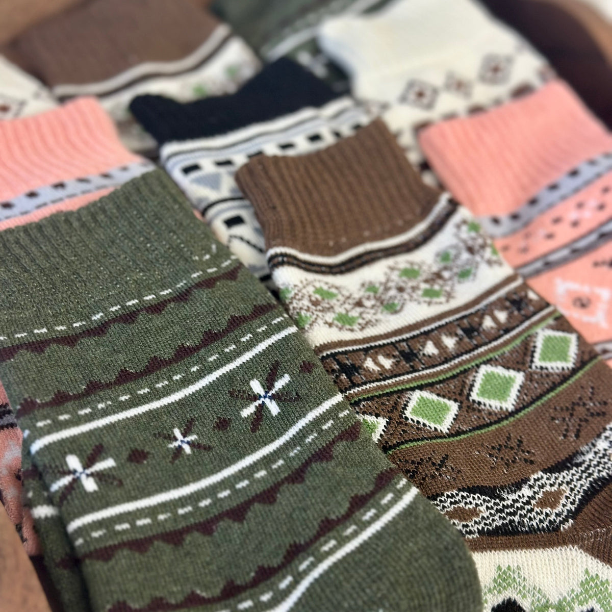 Collection of patterned socks with various designs on a surface. 