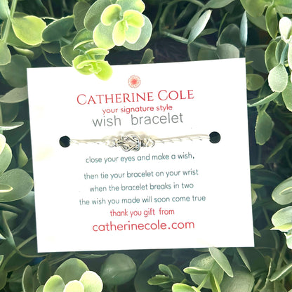 Catherine Cole wish bracelet packaging on a green leafy background