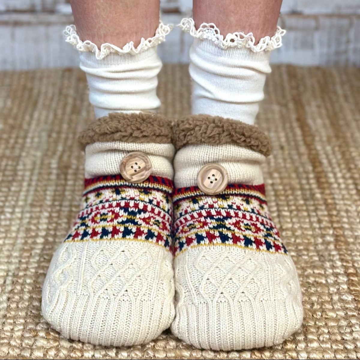 White socks with colorful patterned toes and buttons, worn indoors on a textured floor.  Nordic Slipper Sock Gift Set - Grip Bottom +organic lace Socks + Wish Bracelet