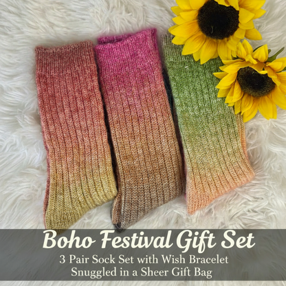 Three pairs of ribbed knit socks in gradient colors are arranged on a white faux fur background with yellow sunflowers. Text at the bottom reads 'Flower Girl Gift Set' and describes a 3 pair sock set with a wish bracelet.