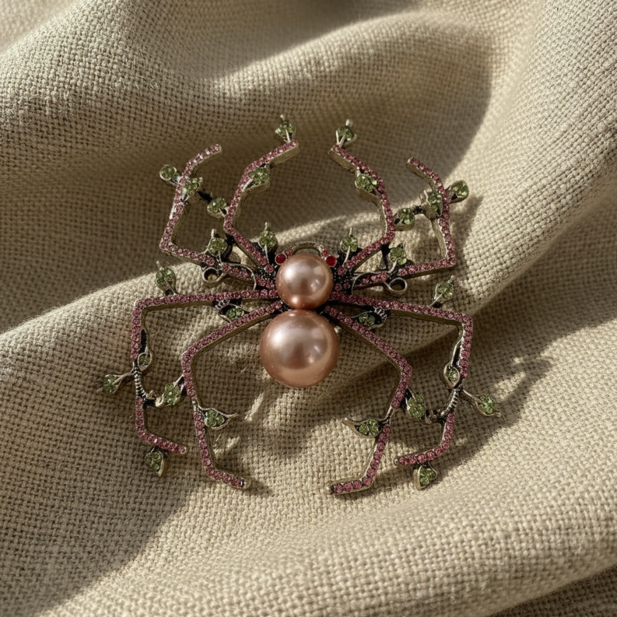 Spider-shaped brooch with pink pearls on a textured beige fabric background, Pearl & Crystal Spider Brooch Pin - Charlotte's Garden Vintage Jewelry