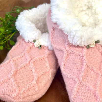 Pink slippers with white fur lining on a wooden surface.  
Pretty in Pink Slipper Sock Gift Set - Grip Bottom + Floral Socks + Wish Bracelet

