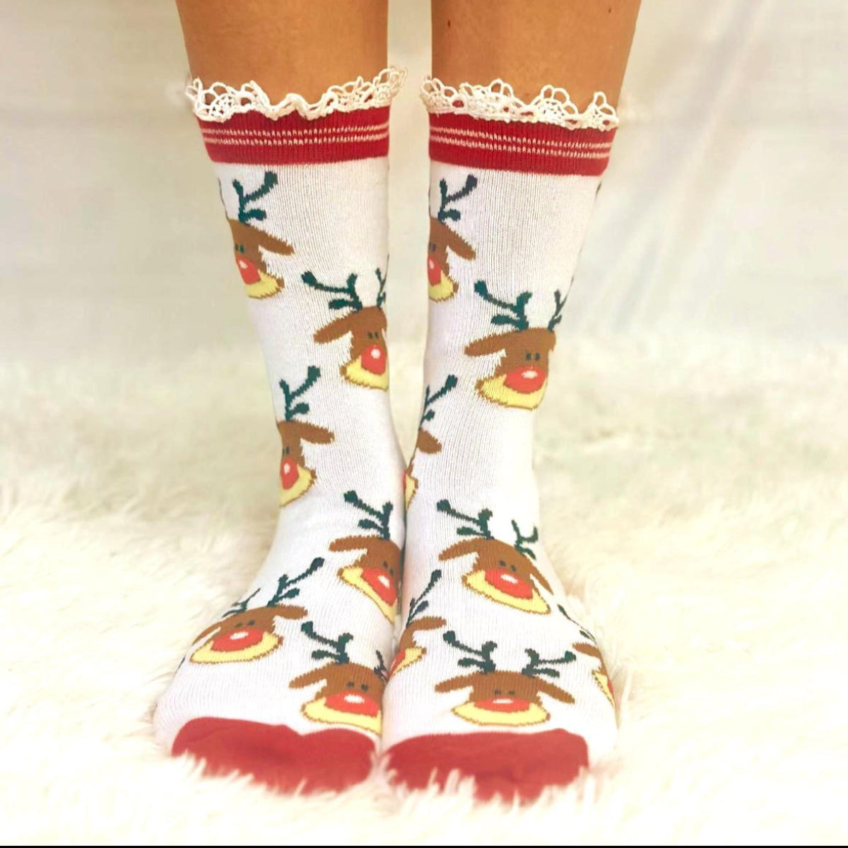 Red reindeer lace topped socks with Rudolph design"
"RUDOLPH Christmas socks with natural cotton lace trim"
"Festive red holiday socks with reindeer pattern close-up"