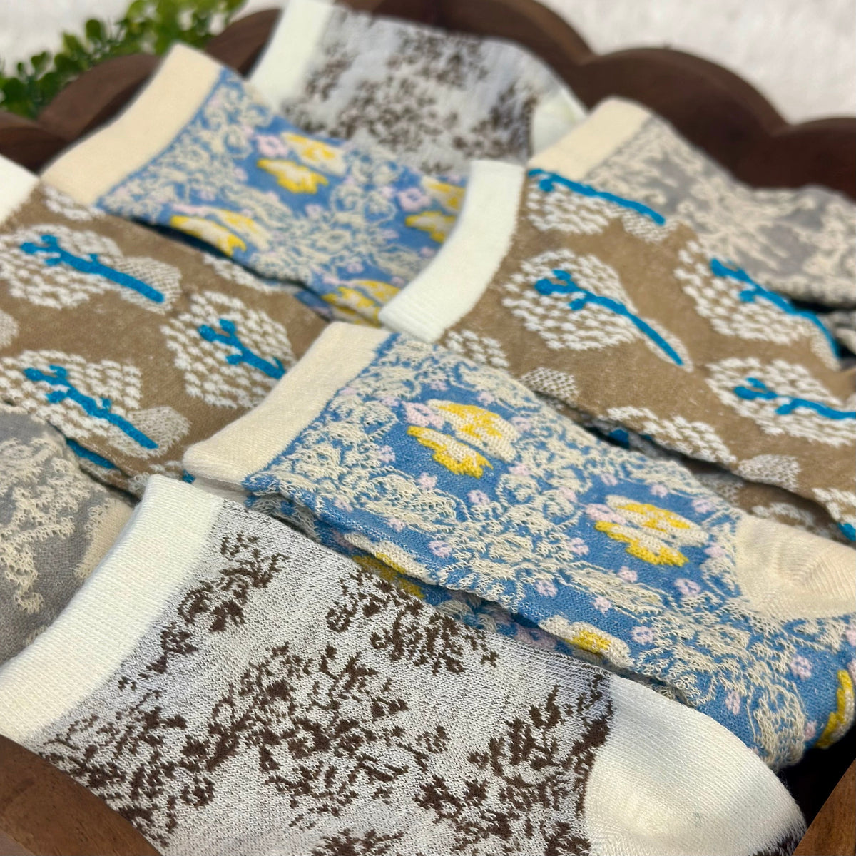 Set of patterned socks in a wooden basket, 