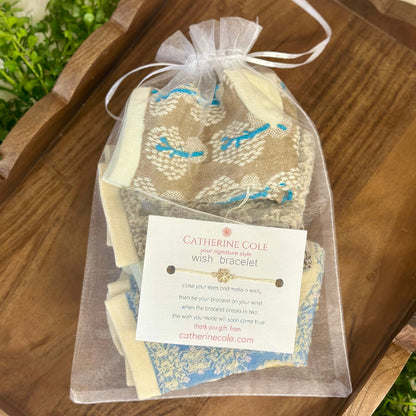 Wish bracelet in a clear bag with a label on a wooden surface
