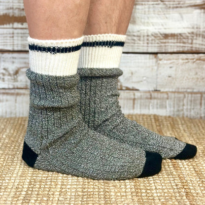 Gray and white socks worn by a person on a woven surface  Striped Marled Slouch Socks Unisex 10-14 - Salt & Pepper