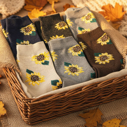 Set of sunflower-patterned socks on a wooden tray with sunflowers on a white fur background  Sunflower Patterned Ankle Socks 5-Pack Bundle with Wish Bracelet - Women's 