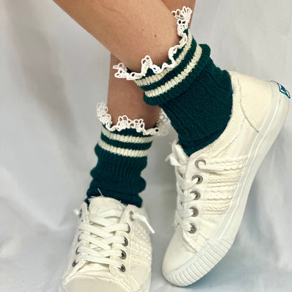 White sneakers with green and white striped socks on a plain background, VARSITY striped crew socks - hunter green