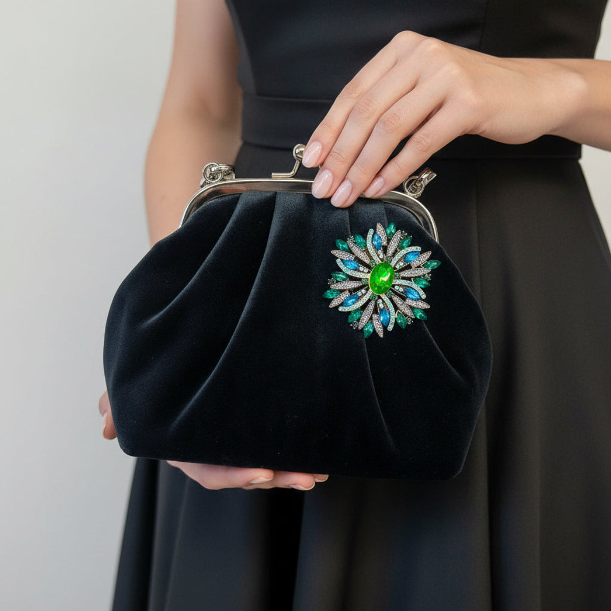 "Vintage sunburst brooch pinned on a black velvet evening bag – green teal aqua – Catherine Cole"