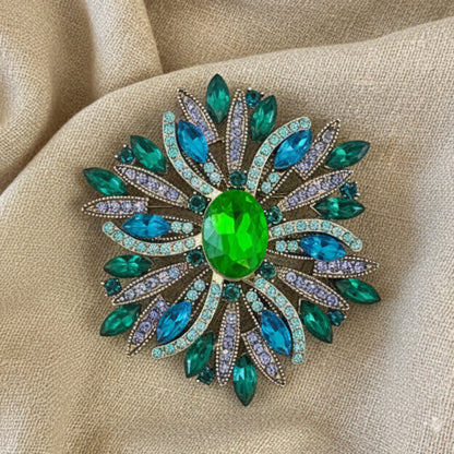Vintage sunburst brooch in green teal and aqua displayed in frame – Catherine Cole