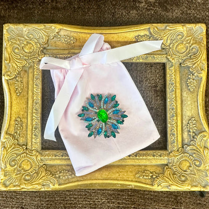 Vintage sunburst brooch on pink velvet gift bag – gift-ready costume jewelry by Catherine Cole
