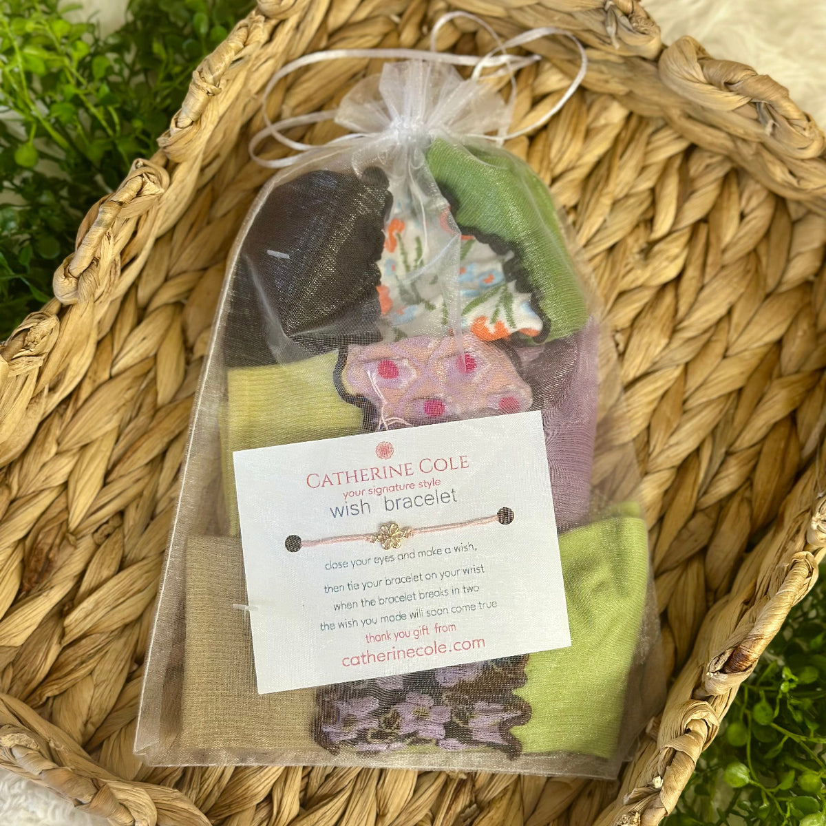 Catherine Cole wish bracelet packaging with a tag on a woven surface