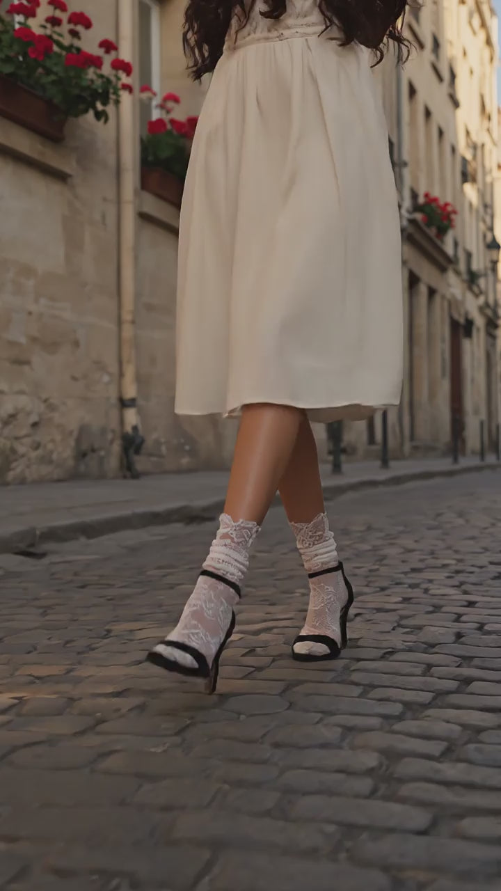 French woman walking in Paris wearing Catherine Cole Allover White Lace Socks on black heels