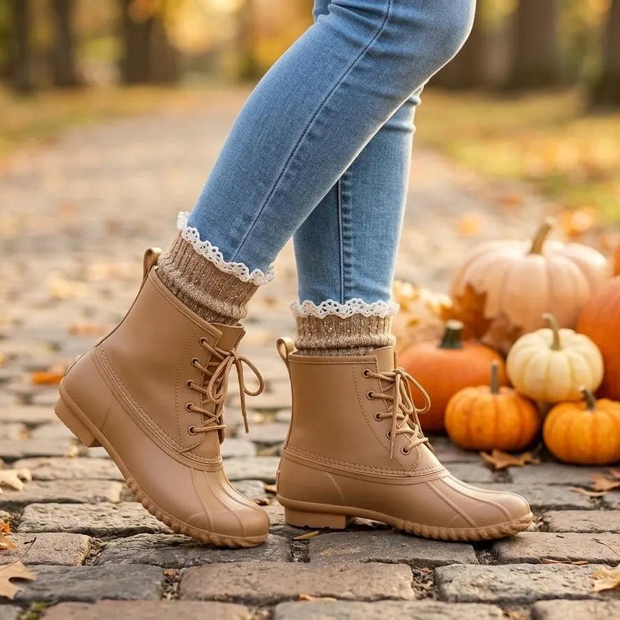 tan speckled lace top ankle socks.  A person wearing tan lace-up ankle boots with cream lace socks, standing on a cobblestone path outdoors with pumpkins and autumn leaves in the background.