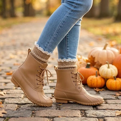 tan speckled lace top ankle socks.  A person wearing tan lace-up ankle boots with cream lace socks, standing on a cobblestone path outdoors with pumpkins and autumn leaves in the background.