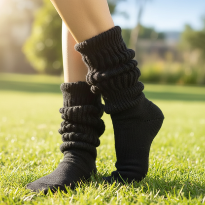 Vintage-style black  cotton slouch socks layered over athletic shoes for a 90s royal streetwear look.