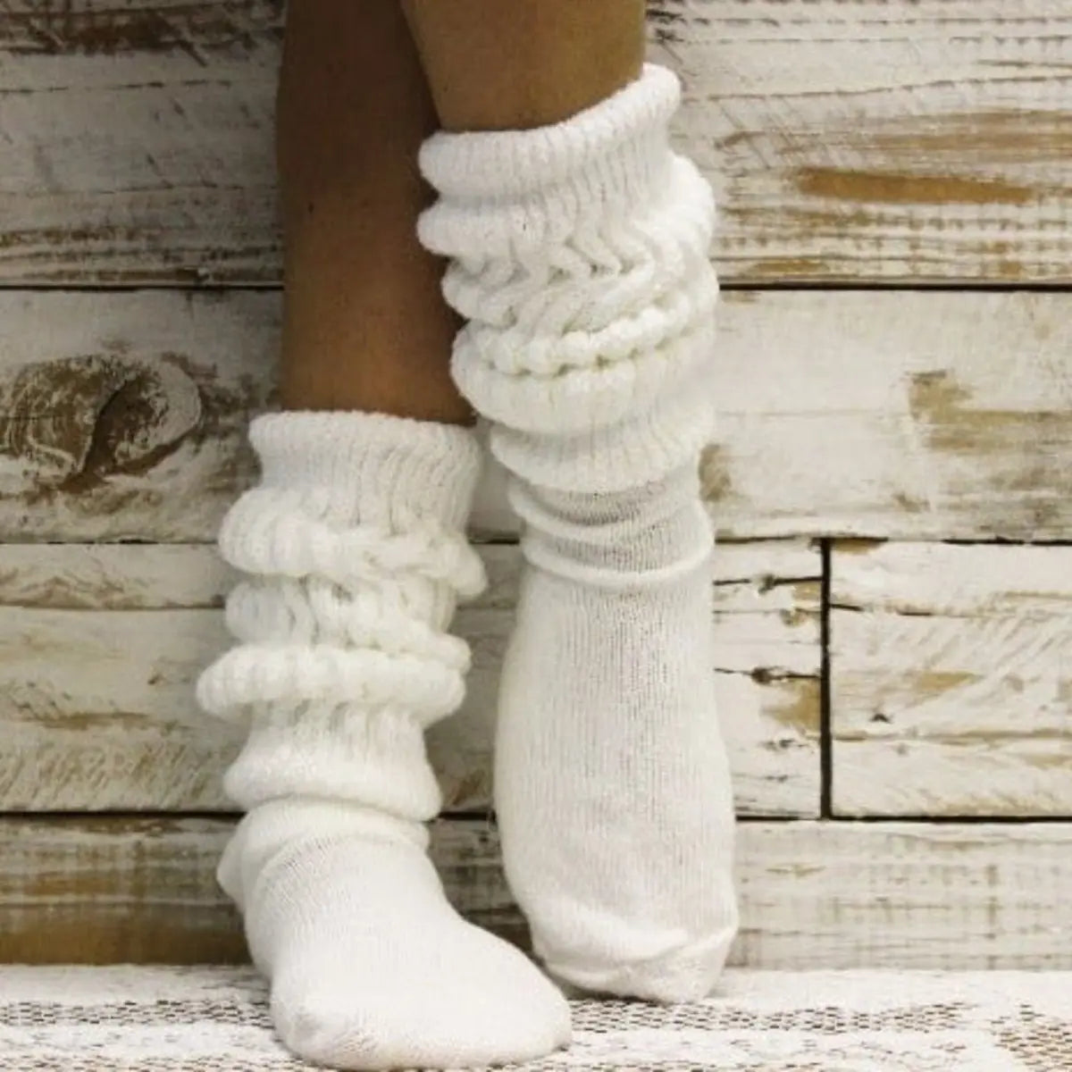 White knitted socks on a wooden background