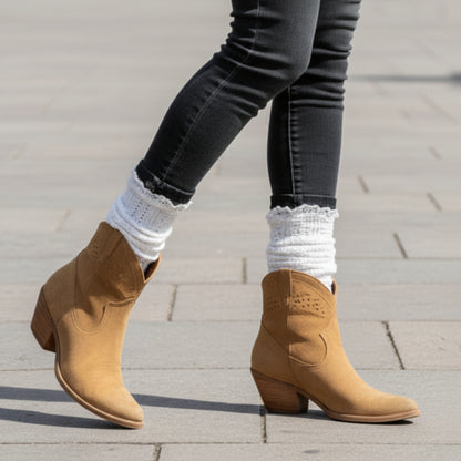 Person wearing white socks on a wooden floor with a textured rug. lace slouch socks for women