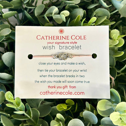 Catherine Cole wish bracelet packaging on a green leafy background